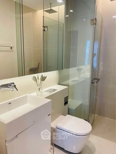 Modern bathroom with glass shower and sleek fixtures