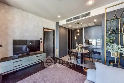 Modern living room with open kitchen, stylish decor, and cozy dining area.