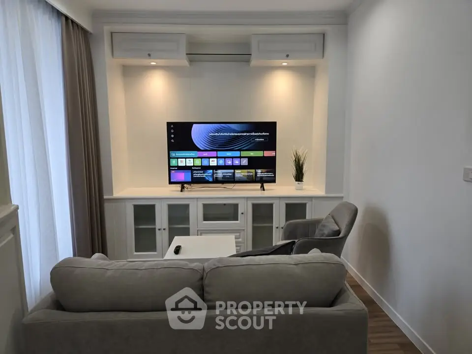 Modern living room with stylish furniture and smart TV setup, perfect for relaxation and entertainment.