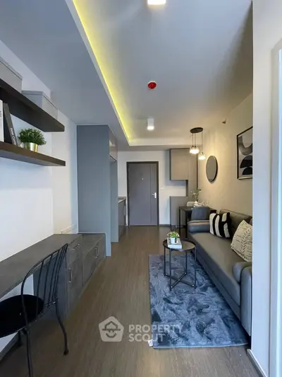 Modern living room with stylish decor and open layout, featuring cozy seating and elegant lighting.