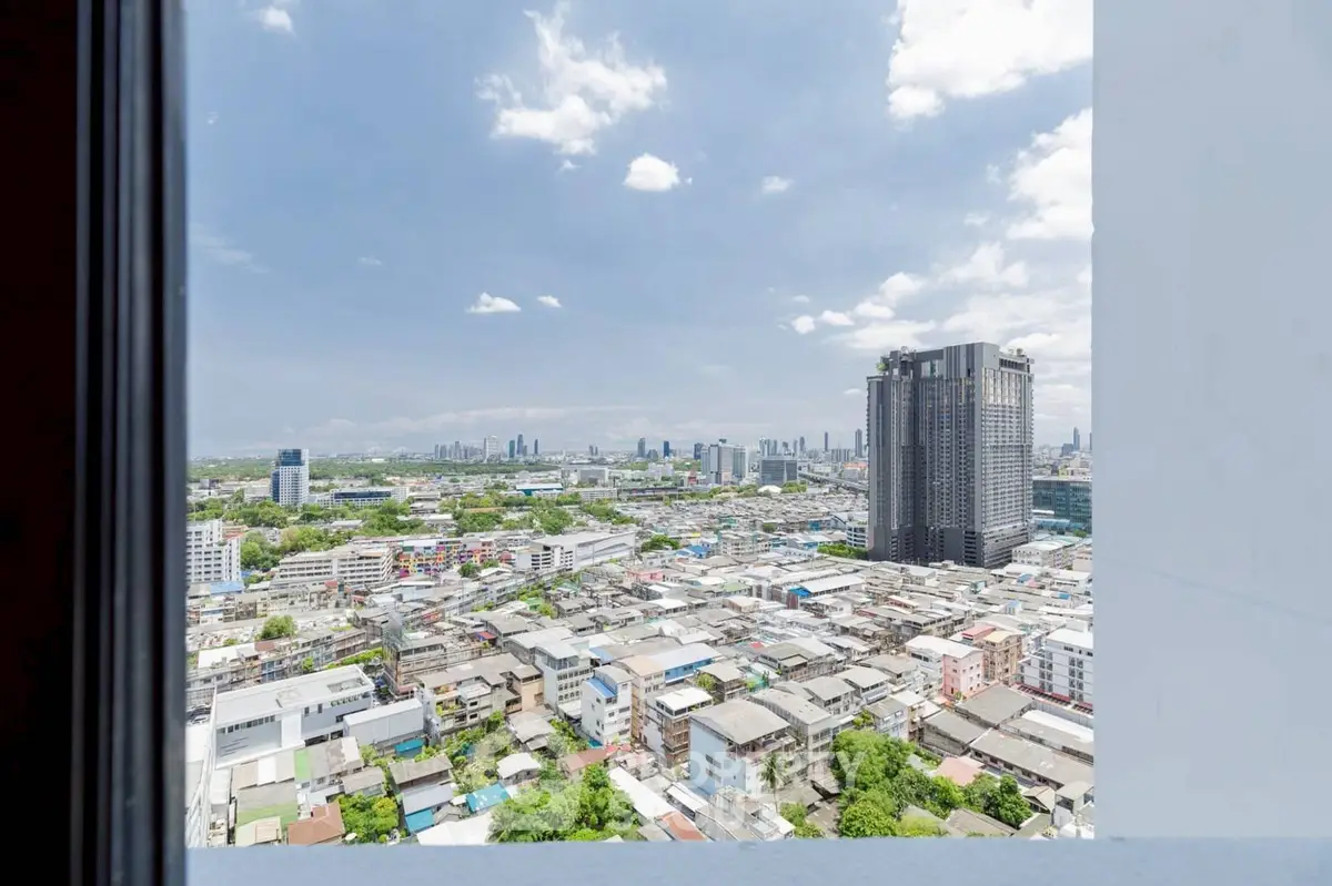 Stunning cityscape view from high-rise building window showcasing urban skyline.