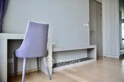 Modern minimalist study area with sleek desk and stylish chair in a contemporary apartment.