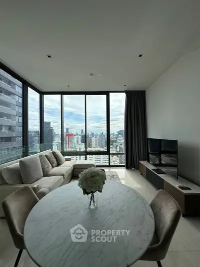 Luxurious living room with stunning city view, modern furniture, and elegant decor in high-rise apartment.