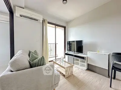 Modern living room with balcony, featuring sleek furniture and natural light.