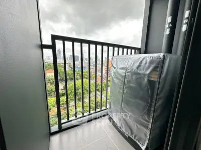 Modern balcony with city view and covered washing machine, perfect for urban living.