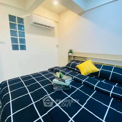 Cozy bedroom with modern decor and stylish bedding in a well-lit space.