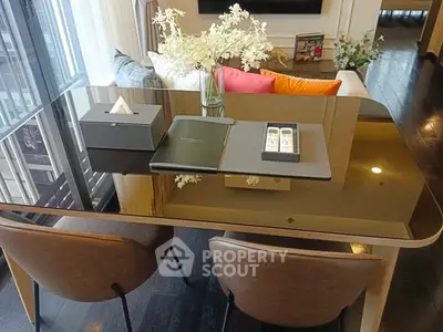 Elegant dining area with glass table and plush chairs in modern apartment