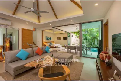 Luxurious open-plan living room with modern decor and garden view, perfect for relaxation and entertaining.
