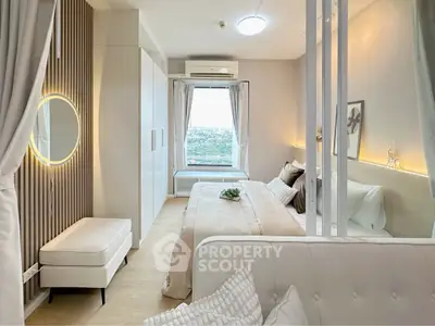 Modern bedroom with elegant decor and large window offering stunning city view