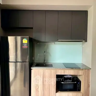Modern compact kitchen with sleek cabinets and stainless steel appliances