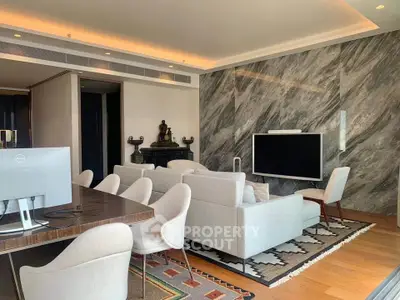 Luxurious living room with modern decor and elegant furniture, featuring a large TV and stylish wall design.