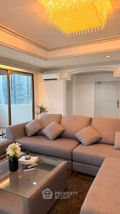 Luxurious living room with elegant chandelier and spacious seating area, perfect for relaxation and entertainment.