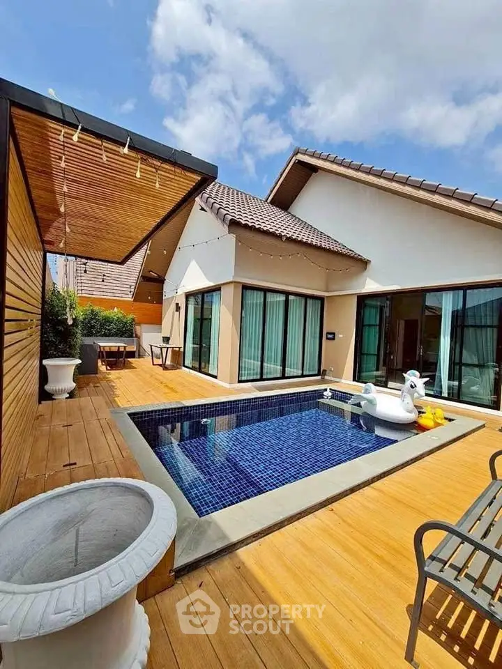 Luxurious villa with private pool and modern deck under clear blue skies.
