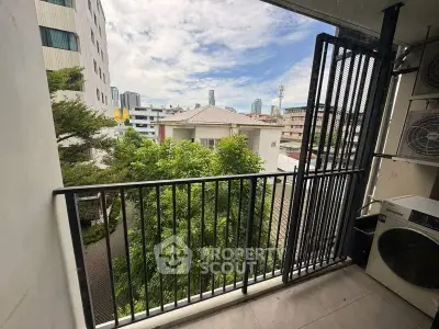 Charming balcony with city view and lush greenery, perfect for relaxation.