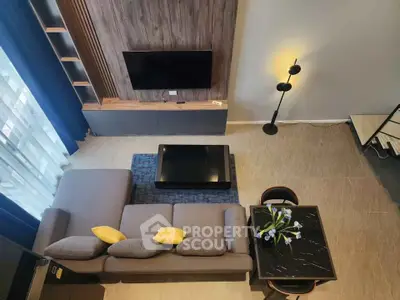 Modern living room with stylish decor, featuring a cozy sofa, sleek TV setup, and elegant lighting.