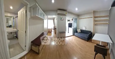 Spacious apartment interior with modern living room and bedroom, featuring wooden flooring and stylish decor.