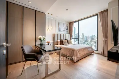Luxurious bedroom with city view, elegant decor, and modern furnishings.