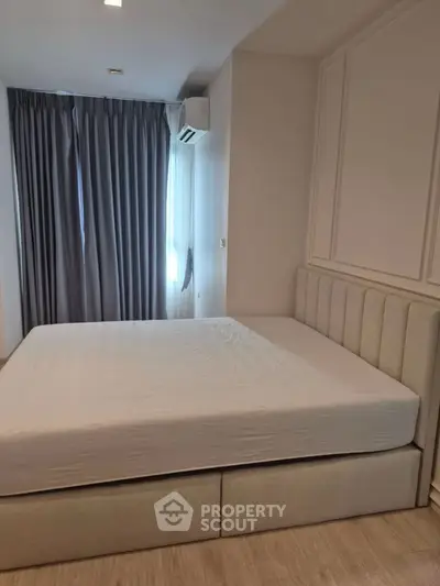 Modern bedroom with stylish bed and elegant curtains, perfect for a cozy retreat.