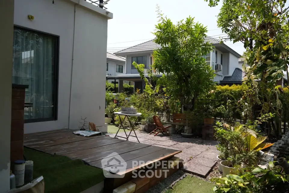 Charming garden view with patio and lush greenery in a residential area
