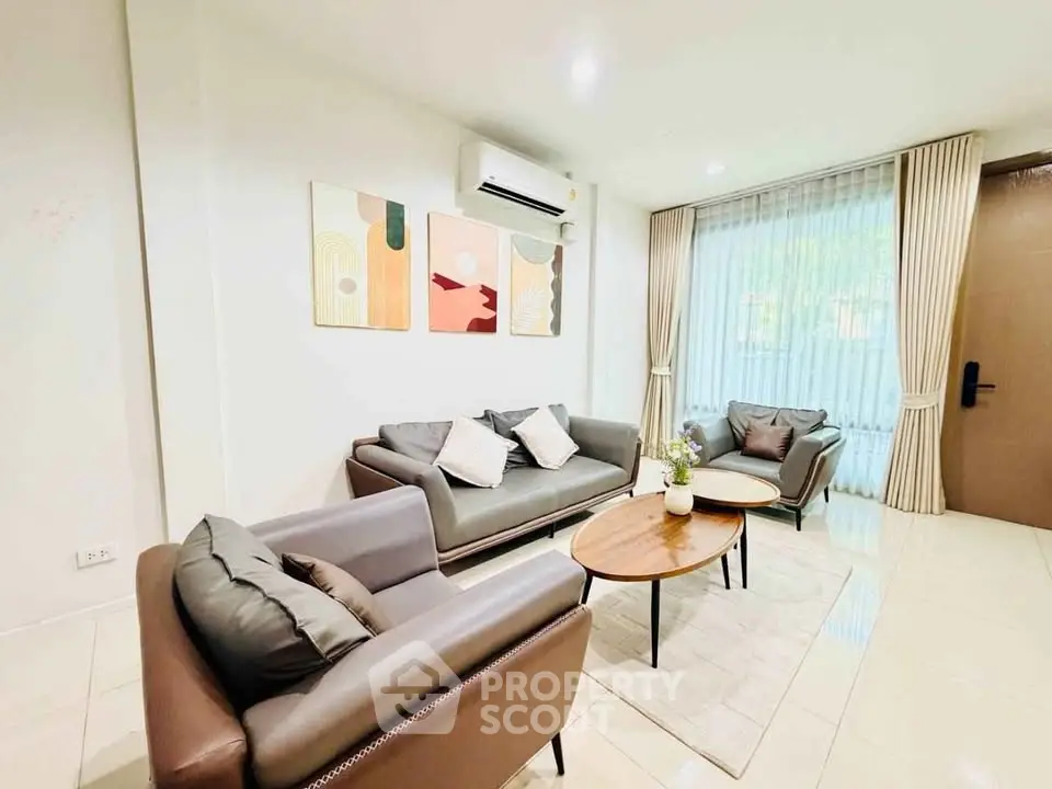 Stylish living room with modern furniture and large window for natural light.