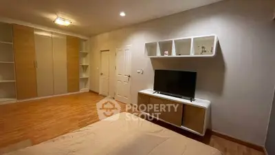 Spacious bedroom with modern furnishings and ample storage in a stylish home.