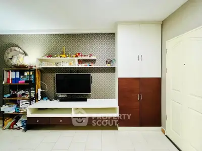 Modern living room with stylish TV unit and ample storage space.