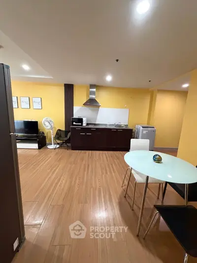 Spacious open-layout kitchen and living area with modern appliances and stylish decor.