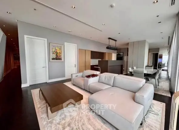 Spacious modern living room with elegant furniture and open kitchen layout in luxury apartment.