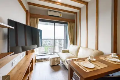 Modern living room with balcony view, featuring sleek furniture and natural light.