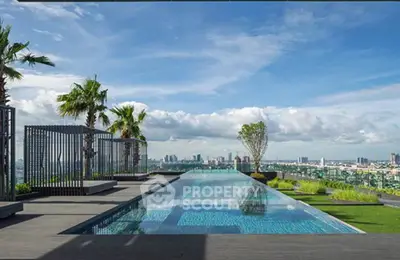 Luxurious rooftop pool with stunning city skyline view and lush greenery.