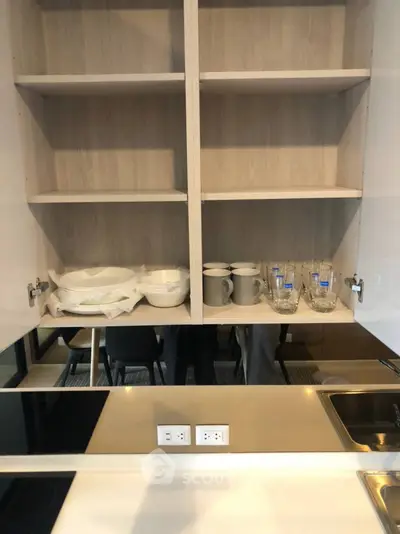 Modern kitchen with open shelving and sleek countertop design