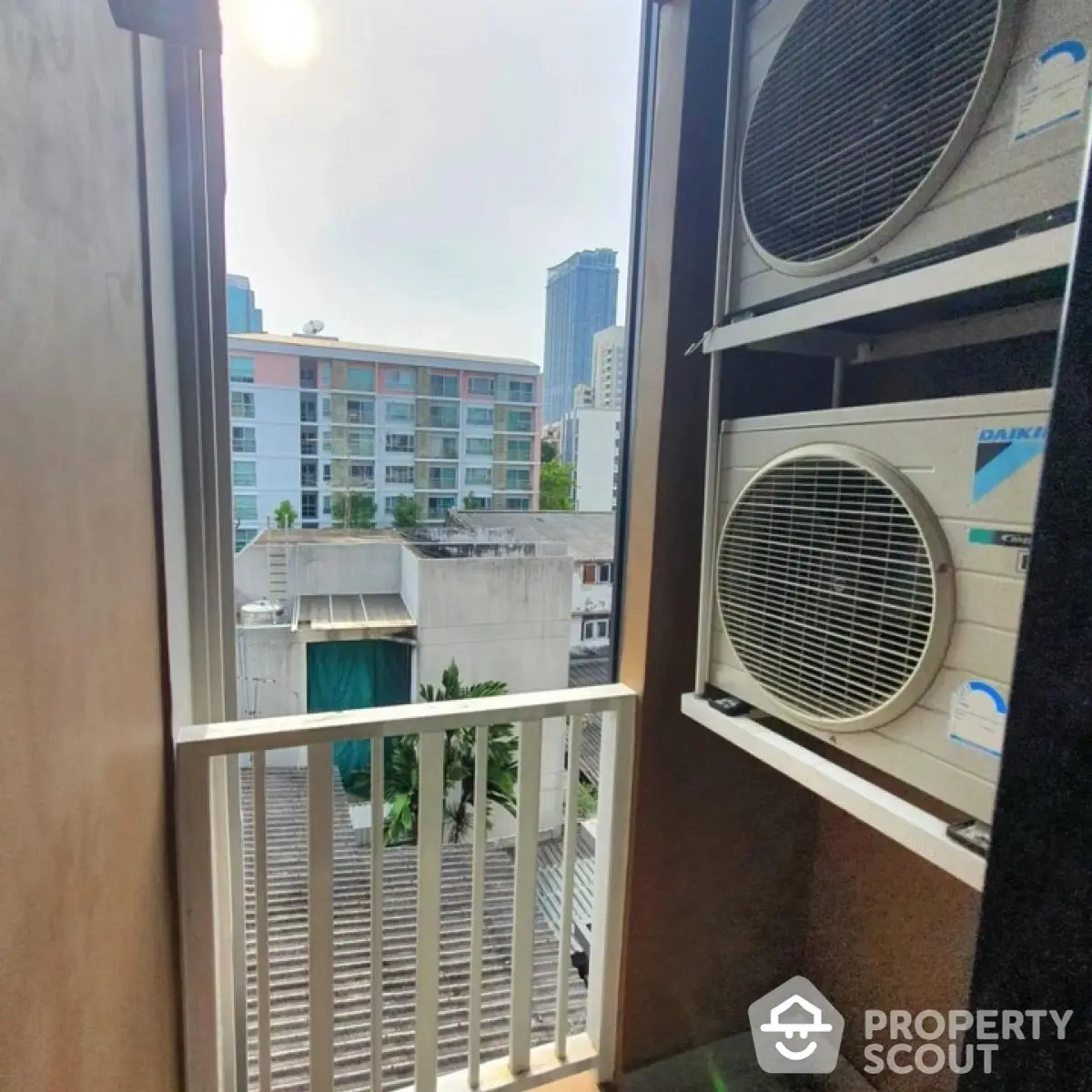 Urban balcony view with air conditioning units in a modern city apartment