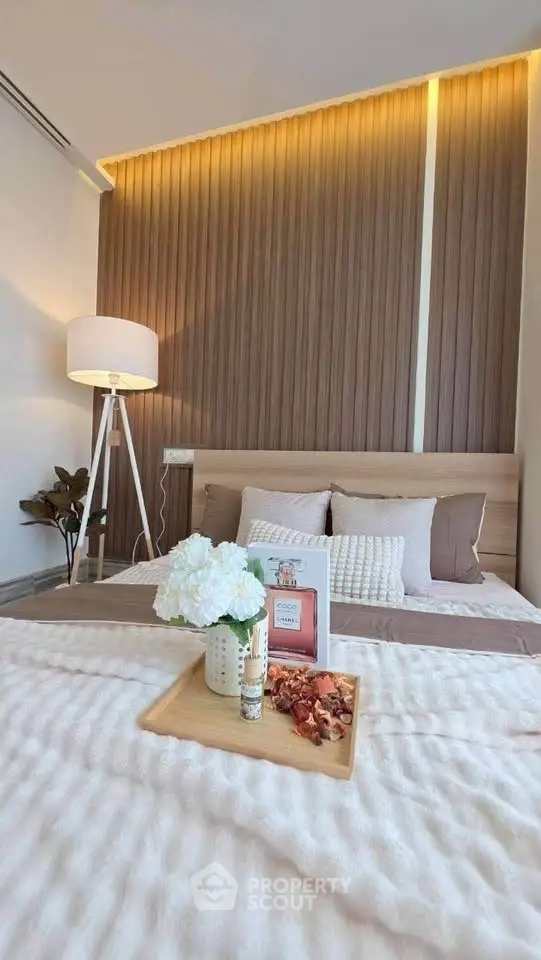 Elegant bedroom with modern decor and cozy ambiance, featuring stylish lighting and plush bedding.