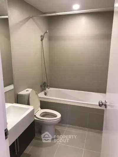 Modern bathroom with bathtub and sleek fixtures in a contemporary apartment.