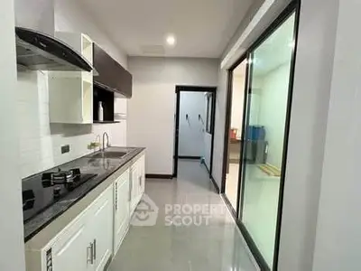 Modern kitchen with sleek design and open layout, featuring gas stove and ample storage space.