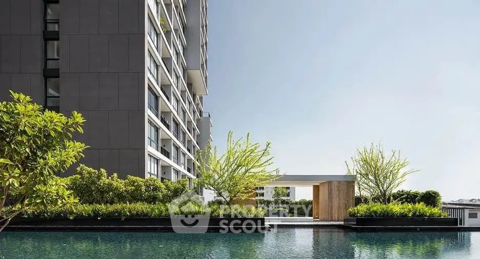 Luxurious modern building with stunning pool and lush greenery, perfect for urban living.