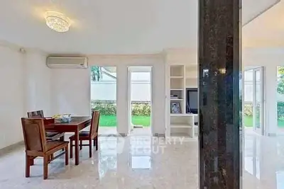 Spacious living room with elegant dining area and garden view