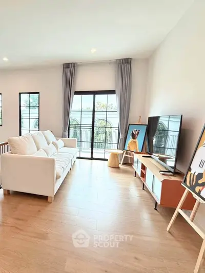 Bright and spacious living room with modern decor and large windows offering natural light.