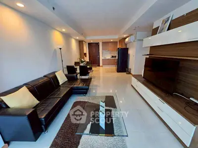 Spacious modern living room with sleek furniture and open kitchen layout