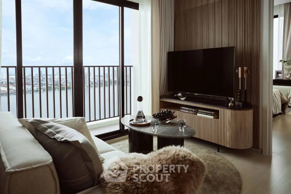 Luxurious living room with stunning city view from high-rise balcony, featuring modern decor and large TV.