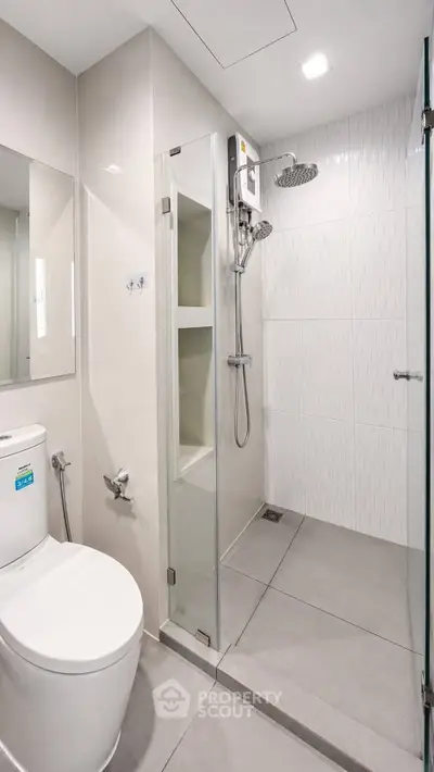 Modern bathroom with glass shower enclosure and sleek fixtures