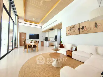 Luxurious open-plan living room with modern decor and high ceilings, featuring a cozy seating area and elegant dining space.