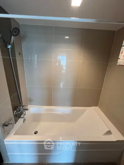 Modern bathroom with sleek bathtub and elegant tile design