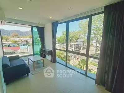 Spacious living room with large windows offering scenic views and abundant natural light.