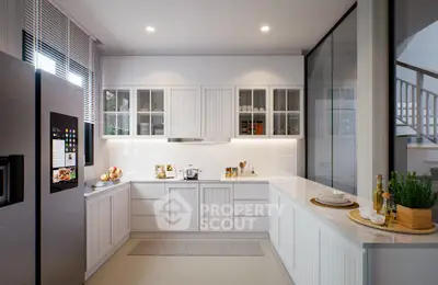Modern kitchen with sleek white cabinetry, stainless steel appliances, and a cozy breakfast nook.