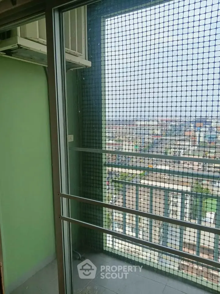 High-rise balcony with safety netting and panoramic city view