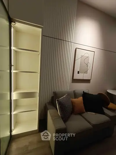 Modern living room with stylish sofa and illuminated shelving, perfect for cozy evenings.