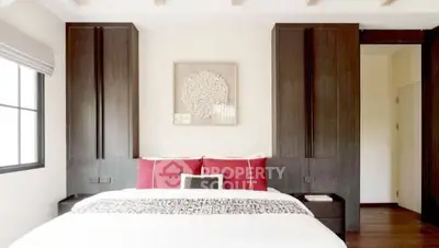 Luxurious bedroom with elegant dark wood accents and stylish decor