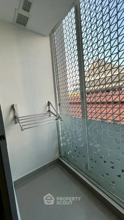 Modern balcony with metal railing and city view, perfect for urban living.