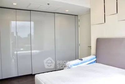 Modern bedroom with sleek built-in wardrobe and cozy bed setup